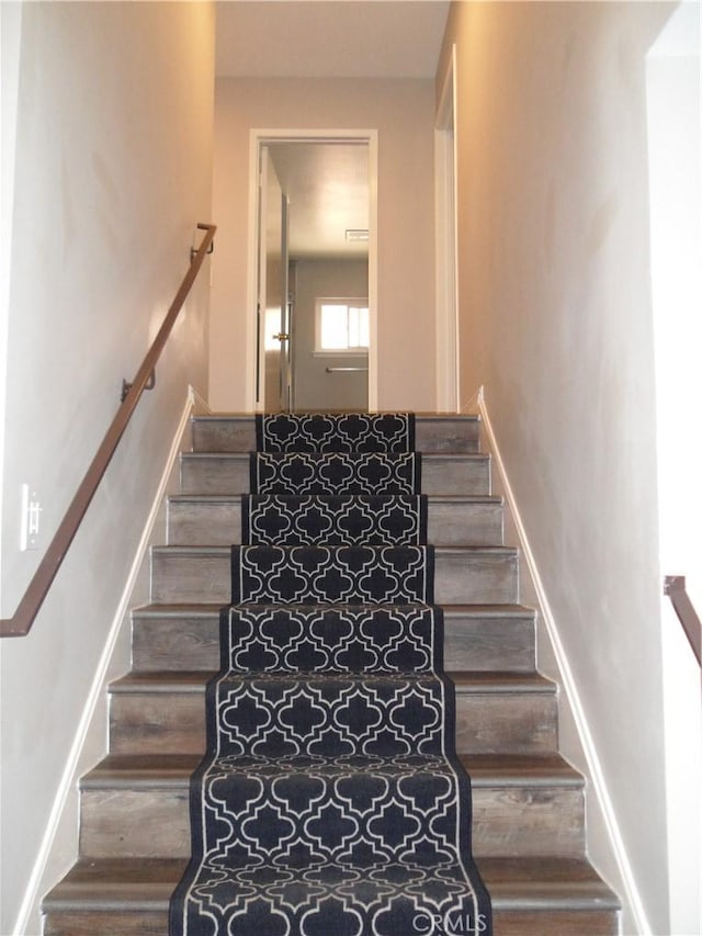 staircase featuring wood finished floors