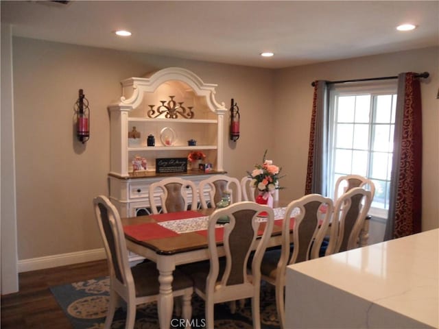 dining space with baseboards, recessed lighting, and dark wood-type flooring