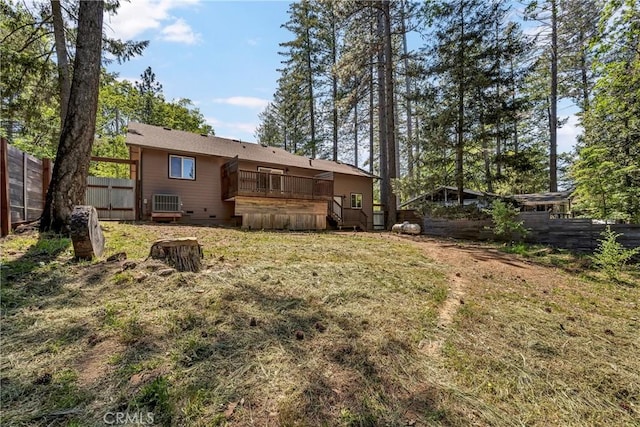 rear view of property with a wooden deck