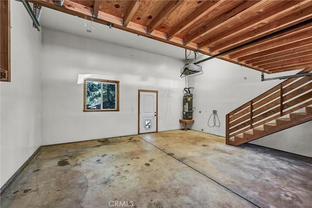 garage featuring a garage door opener and water heater