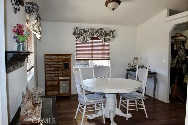 36072 Meadow Grove Rd, Yermo, CA 92398 - dining room featuring arched walkways, wood finished floors, and plenty of natural light