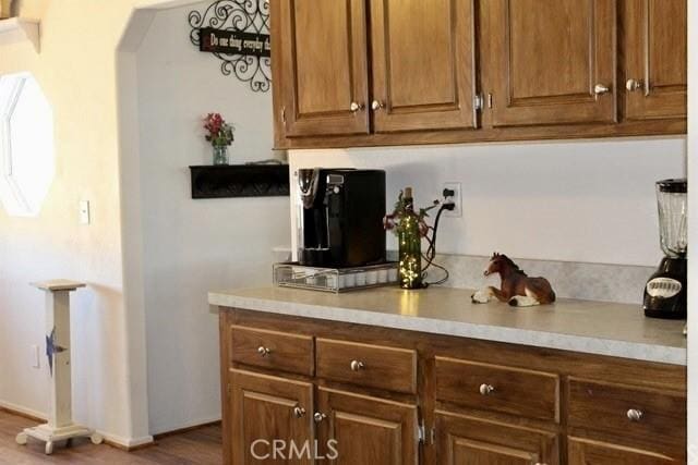 36072 Meadow Grove Rd, Yermo, CA 92398 - bar area with arched walkways, dark wood-type flooring, and baseboards