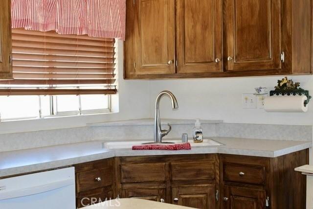 36072 Meadow Grove Rd, Yermo, CA 92398 - kitchen featuring white dishwasher, light countertops, and a sink