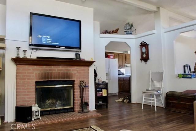36072 Meadow Grove Rd, Yermo, CA 92398 - living area with wood finished floors, a fireplace, and arched walkways