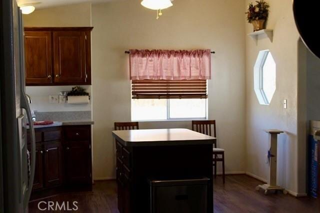 36072 Meadow Grove Rd, Yermo, CA 92398 - kitchen with freestanding refrigerator, dark wood-style flooring, a center island, and baseboards