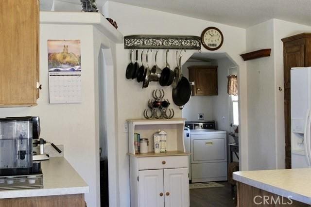 36072 Meadow Grove Rd, Yermo, CA 92398 - kitchen featuring washer / clothes dryer, white refrigerator with ice dispenser, arched walkways, and light countertops