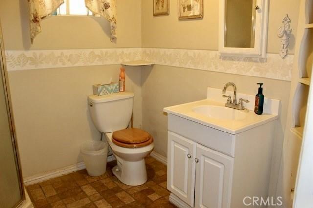 36072 Meadow Grove Rd, Yermo, CA 92398 - full bath featuring toilet, vanity, and a shower with door