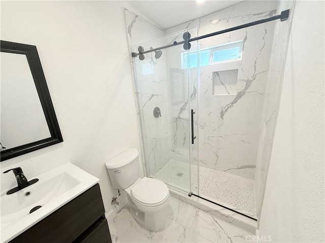 11921 4th Ave, Hesperia, CA 92345 - bathroom with marble look tile flooring, toilet, a marble finish shower, and vanity