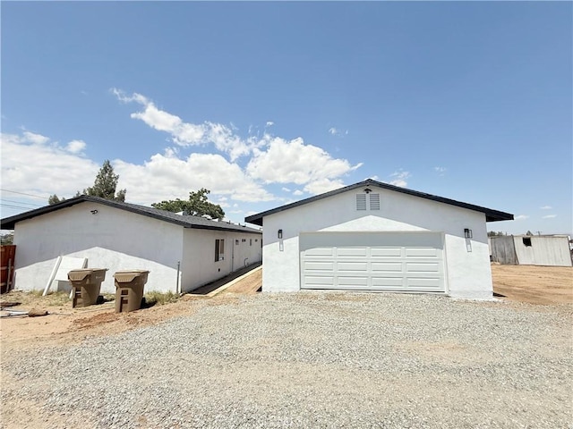 11921 4th Ave, Hesperia, CA 92345 - view of side of home with stucco siding and an outbuilding