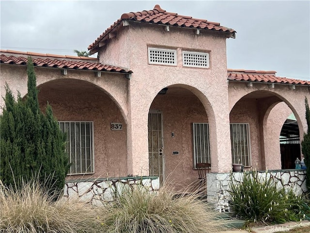 837 W 103rd St, Los Angeles, CA 90044 - view of front of property with a tile roof and stucco siding