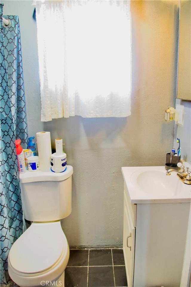 837 W 103rd St, Los Angeles, CA 90044 - bathroom with vanity, toilet, tile patterned floors, a textured wall, and curtained shower