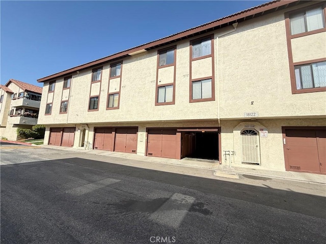18122 Sundowner Way Unit 1108, Canyon Country, CA 91387 - view of building exterior with a garage and driveway