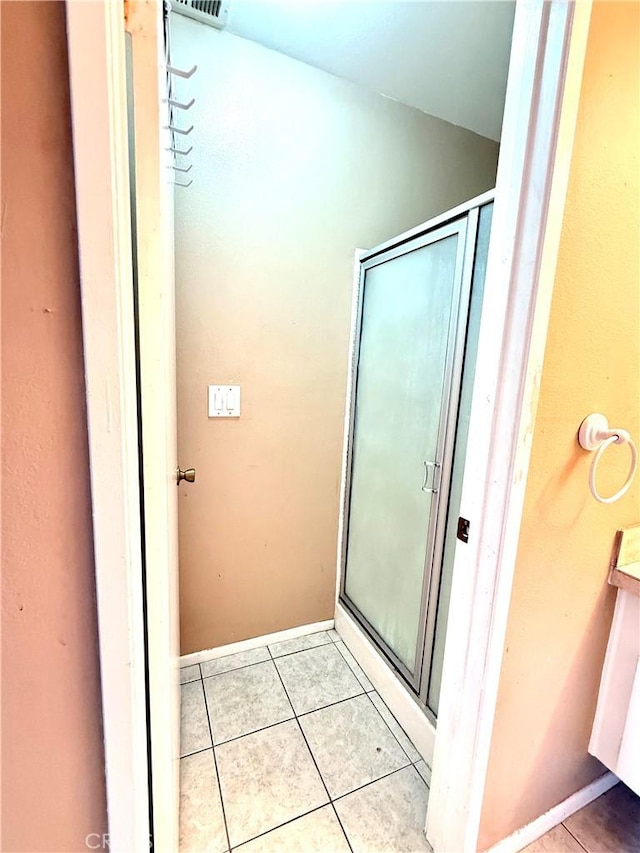 18122 Sundowner Way Unit 1108, Canyon Country, CA 91387 - bathroom with tile patterned flooring, a shower stall, baseboards, and vaulted ceiling