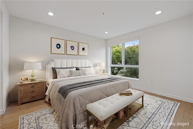 bedroom featuring baseboards, light wood-style flooring, and recessed lighting