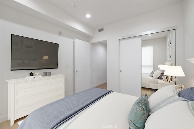 bedroom with light wood-style floors, recessed lighting, a closet, and baseboards