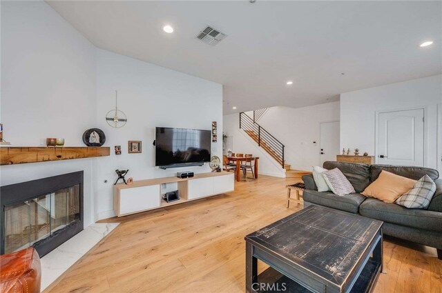 2461 Oneida St Unit B, Pasadena, CA 91107 - living room featuring stairs, light wood-style flooring, a fireplace with flush hearth, and recessed lighting