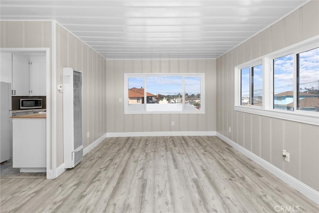 540 Avalon St, Morro Bay, CA 93442 - unfurnished living room with a heating unit, light wood-style flooring, and plenty of natural light
