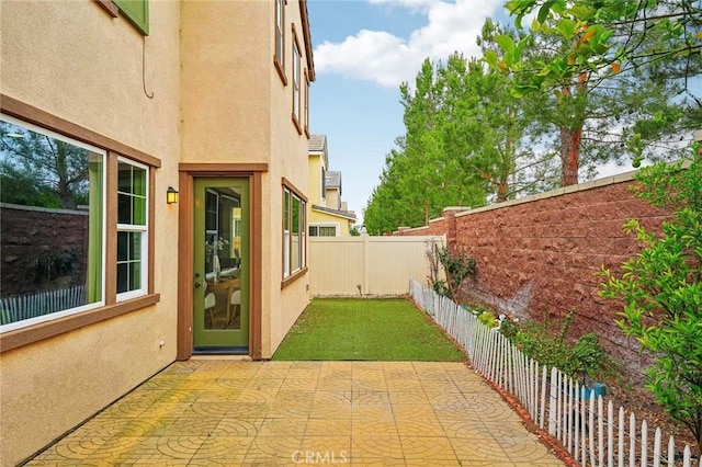 fenced backyard with a patio area