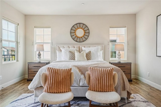 bedroom with wood finished floors and baseboards