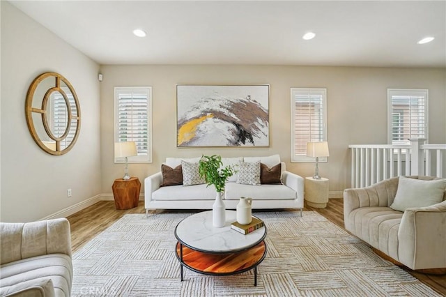 living area with wood finished floors, baseboards, and recessed lighting