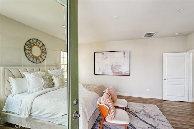 bedroom featuring wood finished floors and baseboards