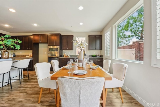 dining room with wood finished floors, recessed lighting, and baseboards