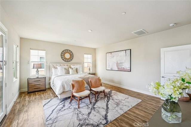 bedroom with wood finished floors and baseboards