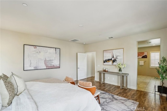bedroom featuring wood finished floors and baseboards