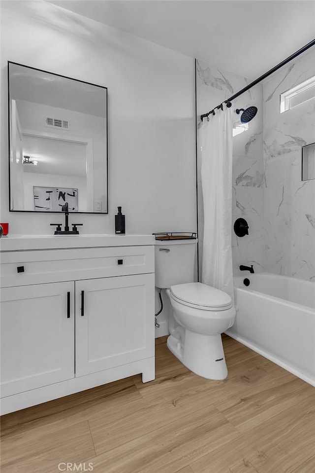 full bath with toilet, shower / bath combo with shower curtain, vanity, and wood finished floors