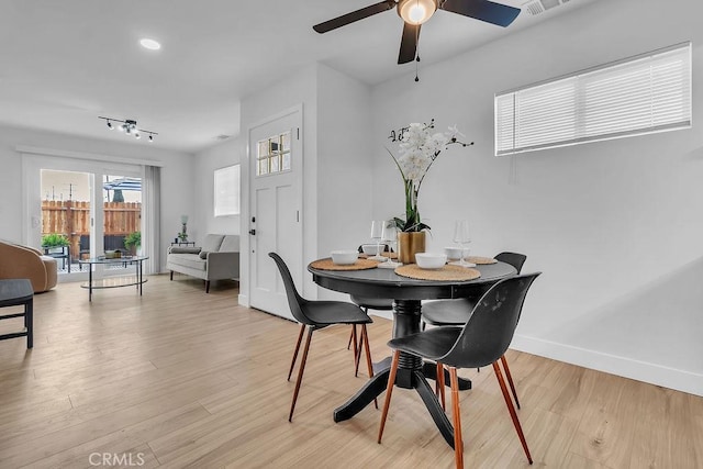 dining space with ceiling fan, light wood-style floors, and baseboards