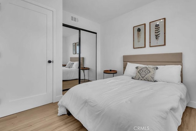 bedroom with a closet and wood finished floors
