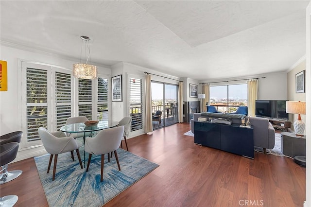 dining area with ornamental molding, dark wood finished floors, and healthy amount of natural light