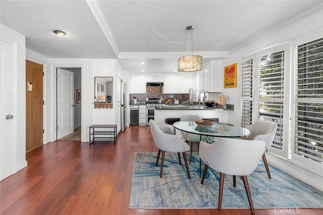 dining area with dark wood-type flooring and ornamental molding