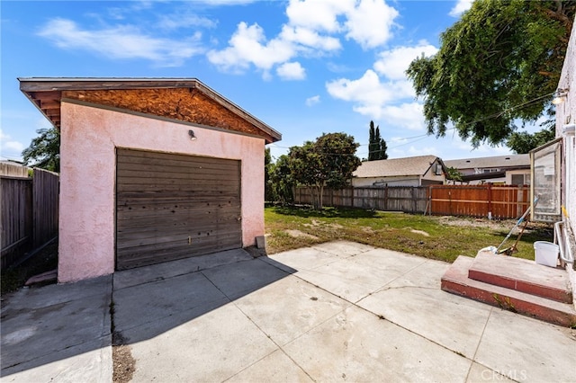 detached garage featuring driveway