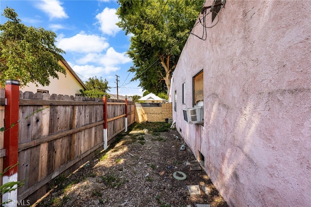 view of yard with fence and cooling unit