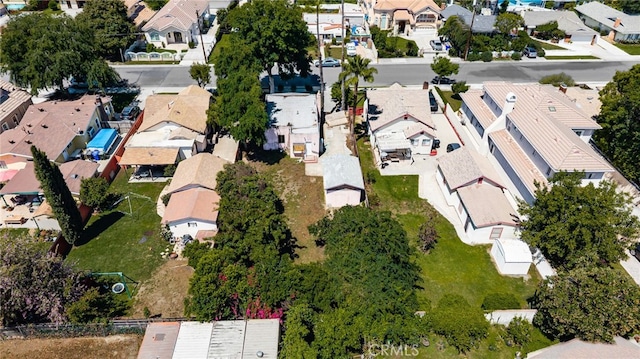 aerial view of property and surrounding area featuring nearby suburban area