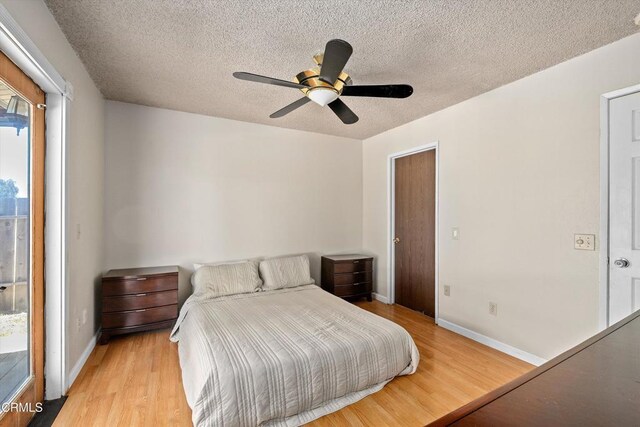 1037 Cortina Ct, Orland, CA 95963 - bedroom with light wood-style flooring, baseboards, a textured ceiling, and a ceiling fan