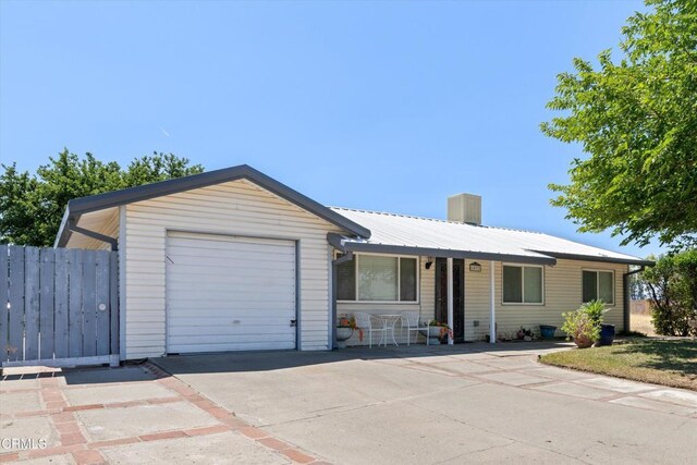 1037 Cortina Ct, Orland, CA 95963 - ranch-style house with concrete driveway, a garage, and metal roof
