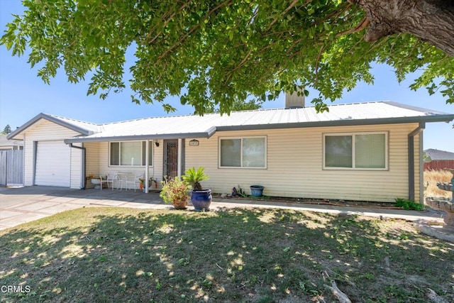 1037 Cortina Ct, Orland, CA 95963 - ranch-style house featuring a garage, metal roof, and driveway