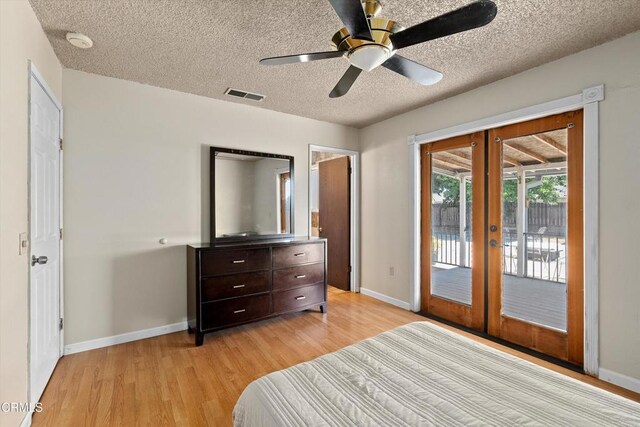 1037 Cortina Ct, Orland, CA 95963 - bedroom with french doors, access to exterior, a textured ceiling, light wood-style floors, and baseboards
