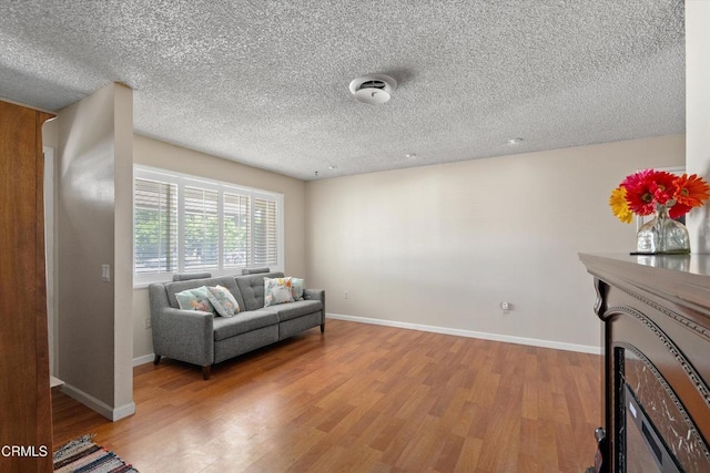 1037 Cortina Ct, Orland, CA 95963 - living area featuring wood finished floors, baseboards, and a textured ceiling