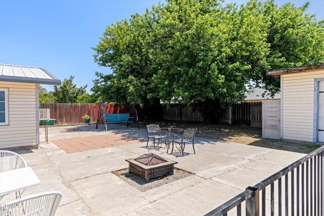 1037 Cortina Ct, Orland, CA 95963 - fenced backyard featuring an outdoor fire pit and a patio