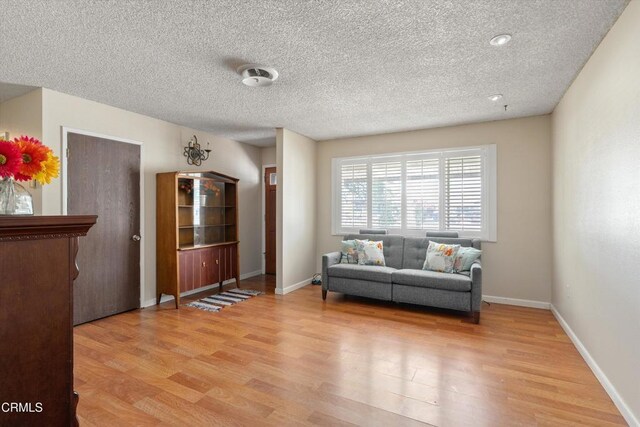1037 Cortina Ct, Orland, CA 95963 - living area with light wood-type flooring, a textured ceiling, and baseboards