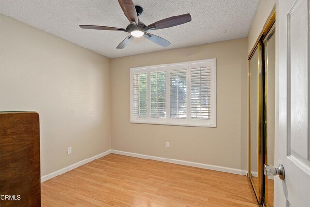 1037 Cortina Ct, Orland, CA 95963 - unfurnished bedroom featuring light wood-type flooring, a textured ceiling, baseboards, and a closet
