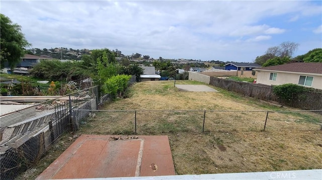 view of yard featuring fence and a residential view