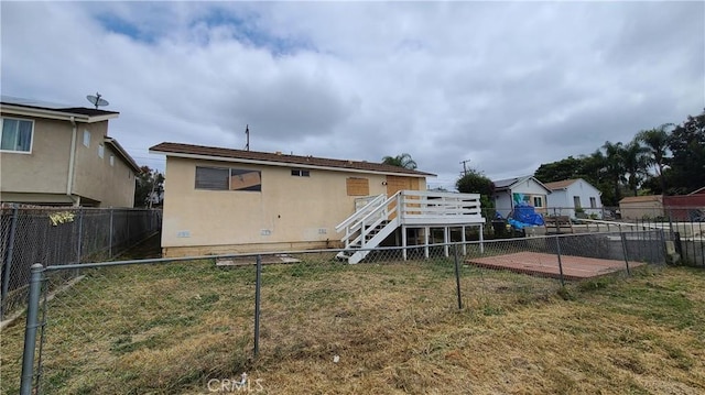back of house with a wooden deck and stairway