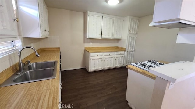 kitchen featuring a sink, white cabinets, dark wood-style flooring, and cooktop