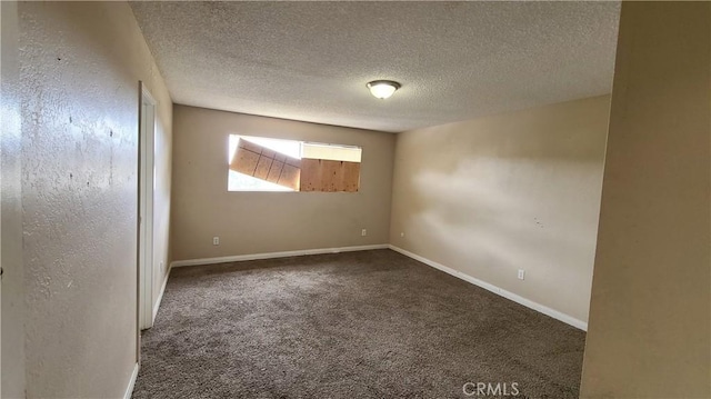 unfurnished room featuring carpet flooring, a textured ceiling, and baseboards