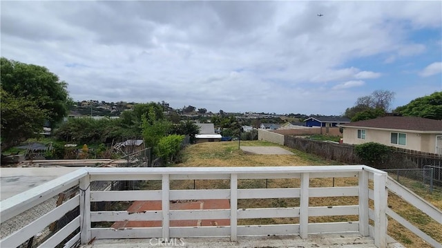 view of yard featuring fence and a residential view