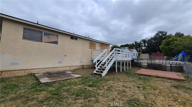 view of yard with a deck and stairs